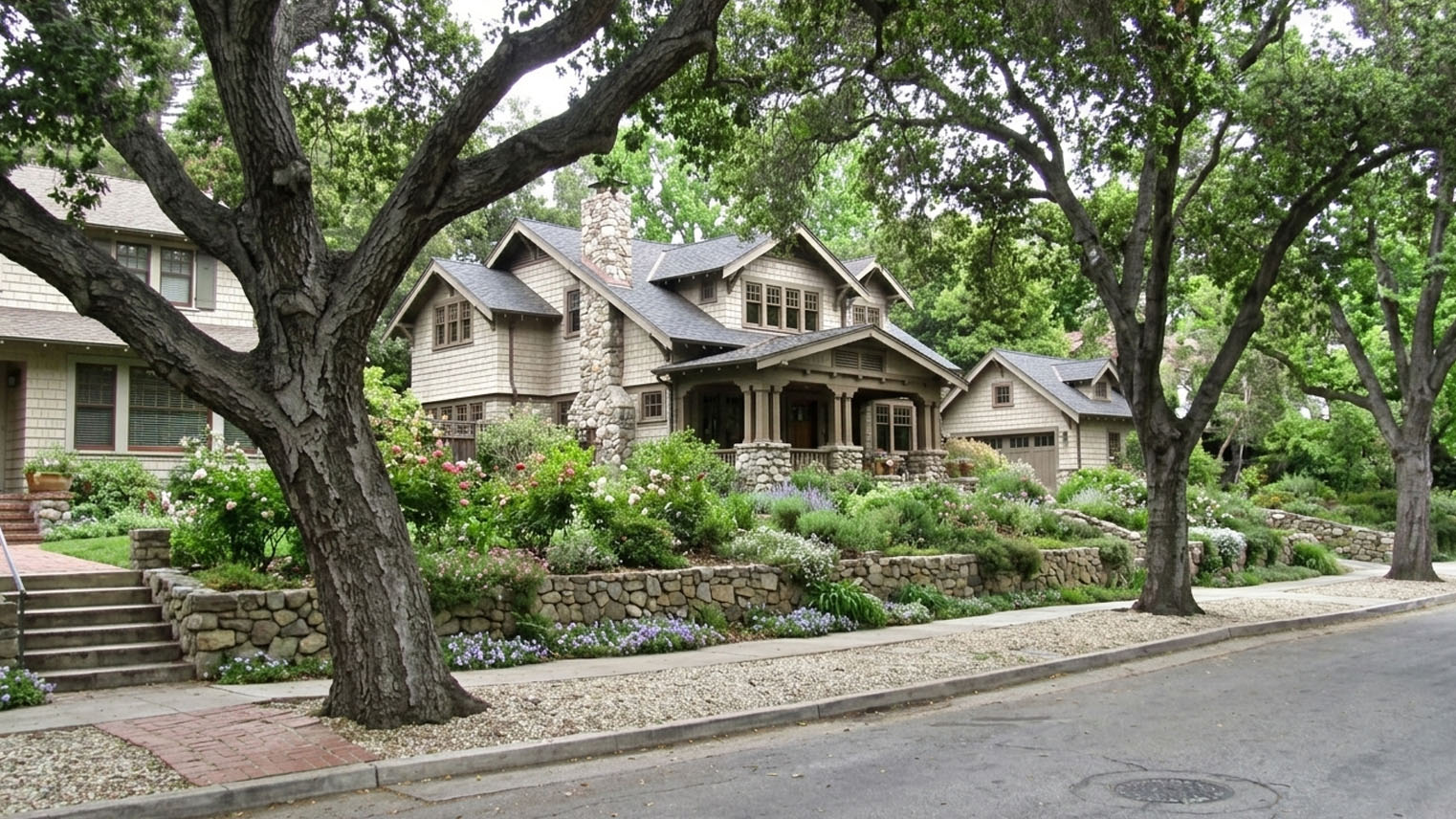 Shingled Craftsman with arroyo stone chimney and porch piers behind stone walls on an Orange Heights street in Pasadena.