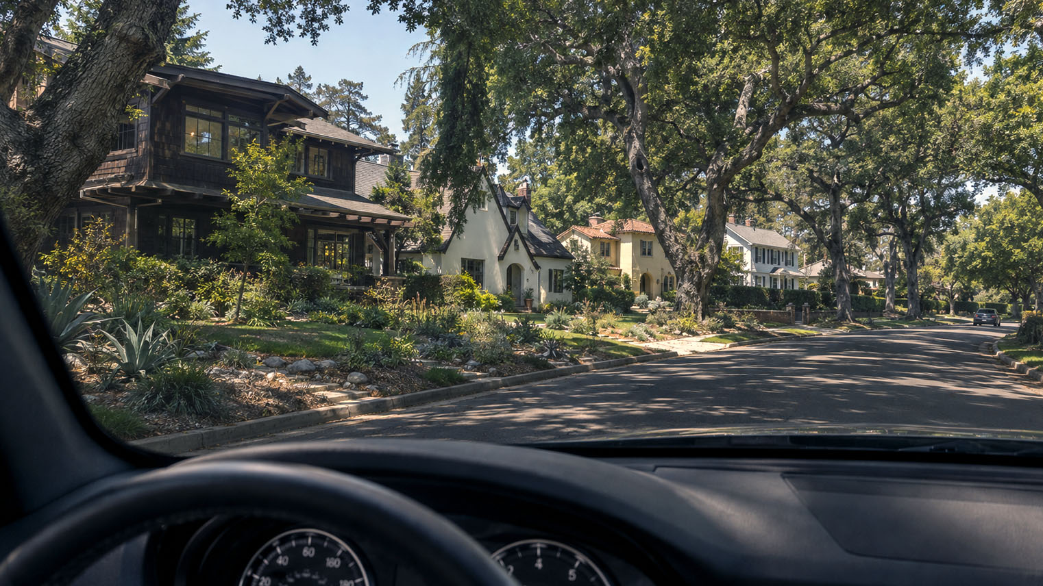 AI generated image from a driver's seat: a curving Prospect Park street, Craftsman and revival homes under mature trees