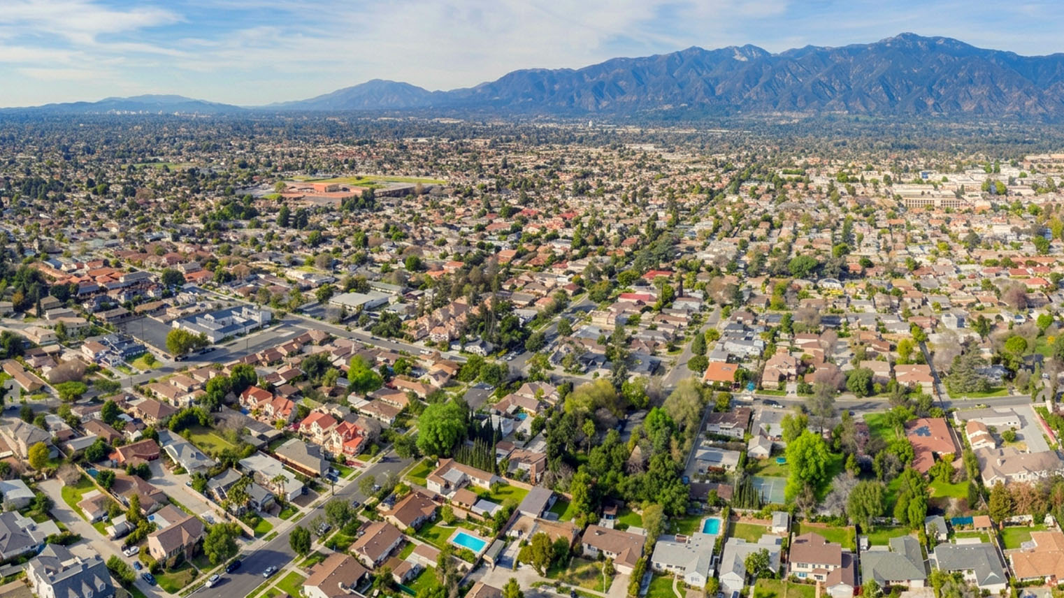 An aerial view across the San Gabriel Valley to the mountains beyond. AI generated image by Greg Anderson.